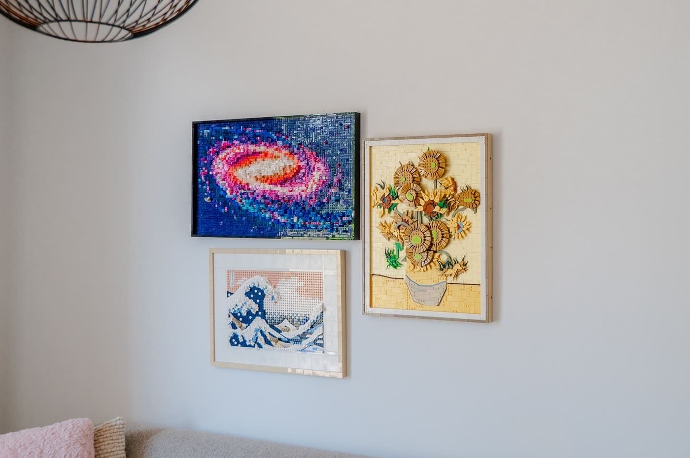 Three framed artworks on a wall.