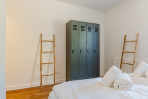 A bedroom with a bed, a wardrobe, and two wooden ladders. - Holiday home with 5 bedrooms in Ossenisse | Het Hoogland B (Ossenisse)