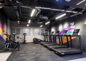 A gym with treadmills, stationary bikes, and a rowing machine. - Student Only Bridle Works (Glasgow)