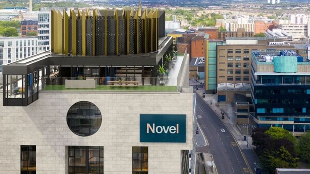 A modern building with a prominent 'Novel' sign, featuring a rooftop garden and a view of the cityscape. - Student Only Bridle Works (Glasgow)