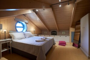 A bedroom with a bed, bedside tables, a window, and a wardrobe. - Villa Porphyra - Four Bedroom Villa, Sleeps 8 (Lefkada City)