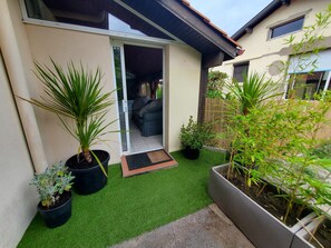 A residential property with a patio area, potted plants, and a sliding glass door leading to an interior space. - A house between the ocean, the Basque Country, and Spain. 5 minutes from the beach (LABENNE)