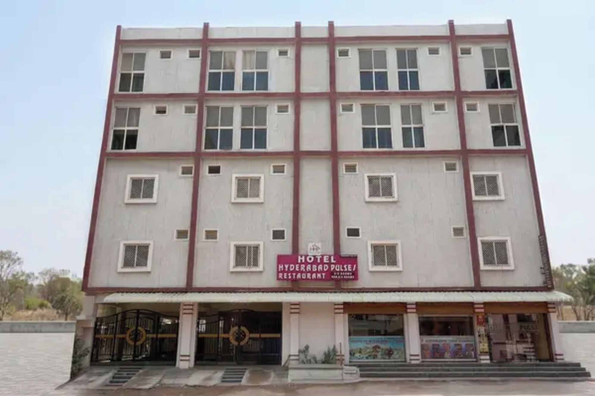 A multi-story hotel with a sign indicating it includes a restaurant.