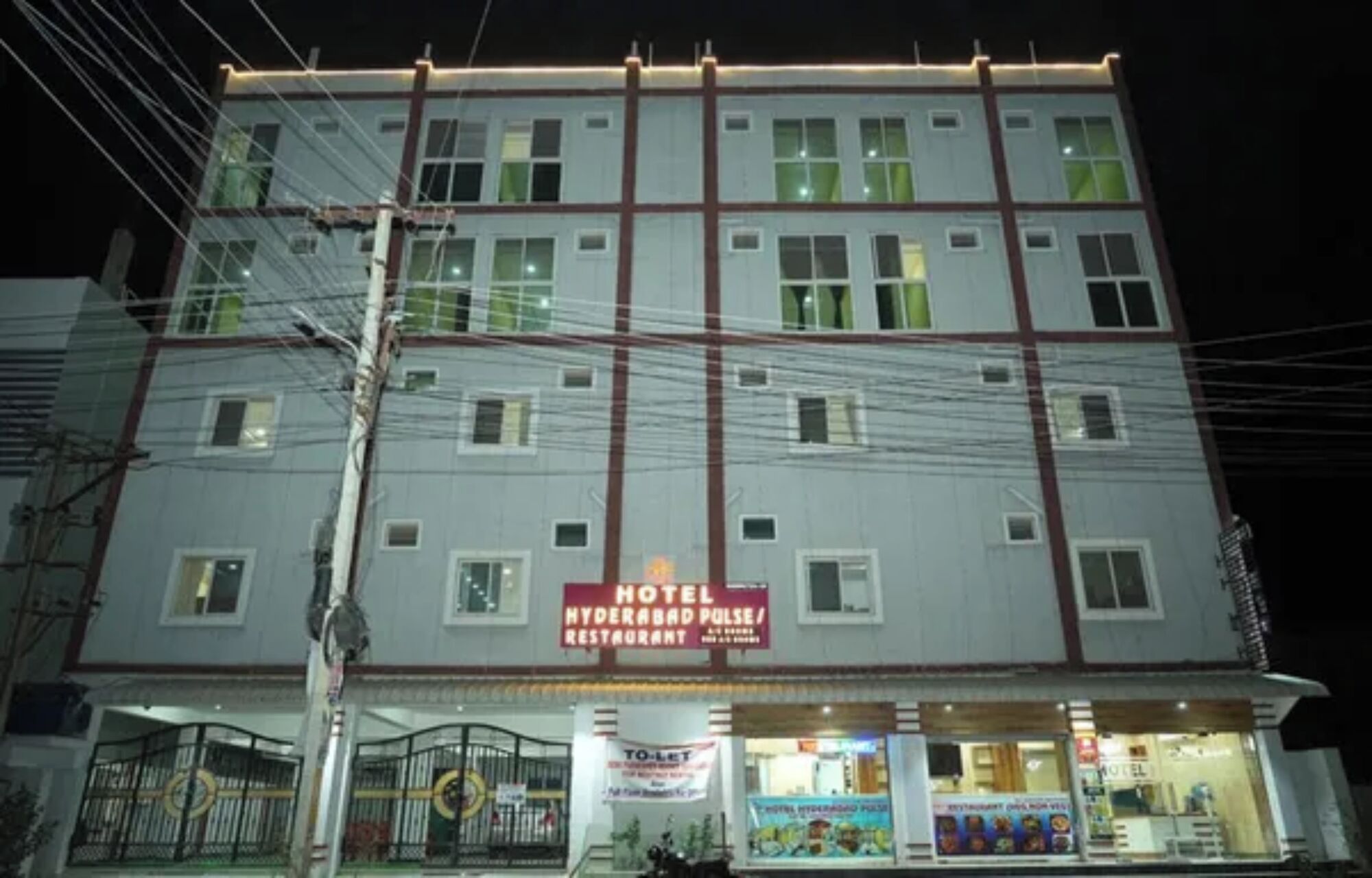 A multi-story hotel with a sign indicating it has a restaurant.