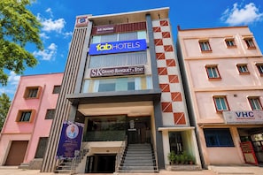 A multi-story hotel with signage for 'fabHOTELS' and 'SKGrand Banquet & Stay'. - Fabhotel Sk Grand Banquet (Visakhapatnam)