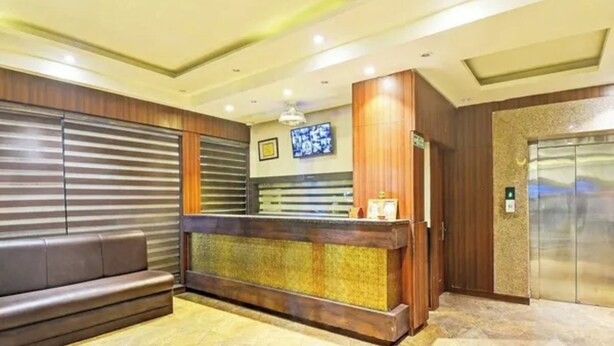 A reception area with a reception desk, a seating area, and an elevator. - Fabhotel Ritz Residency (Jaipur)
