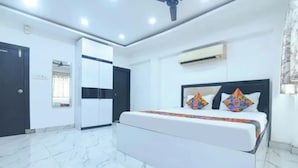 Un dormitorio moderno con cama, armario y equipo de aire acondicionado.
