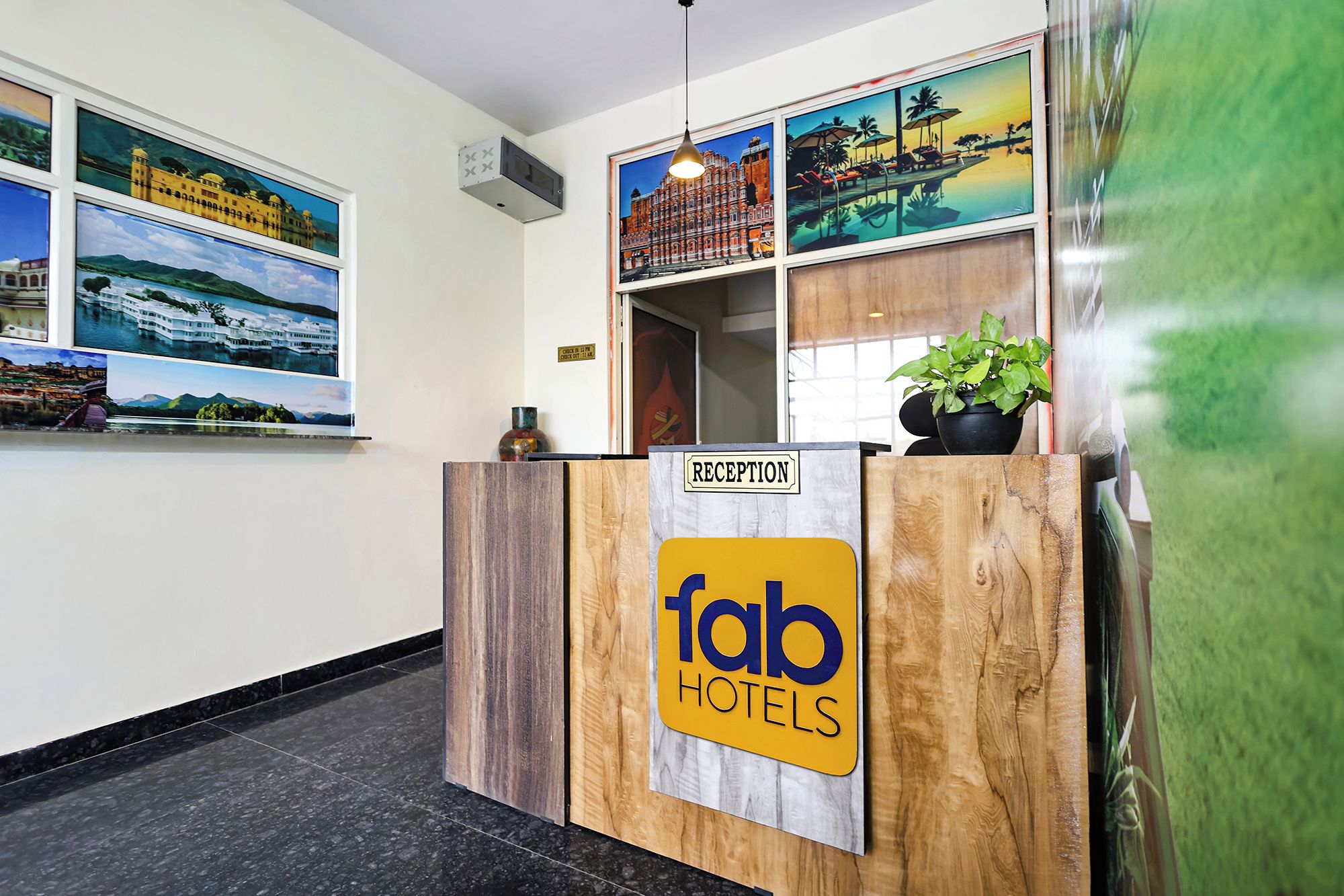 A reception desk with a wooden finish and a sign for 'fab hotels'.