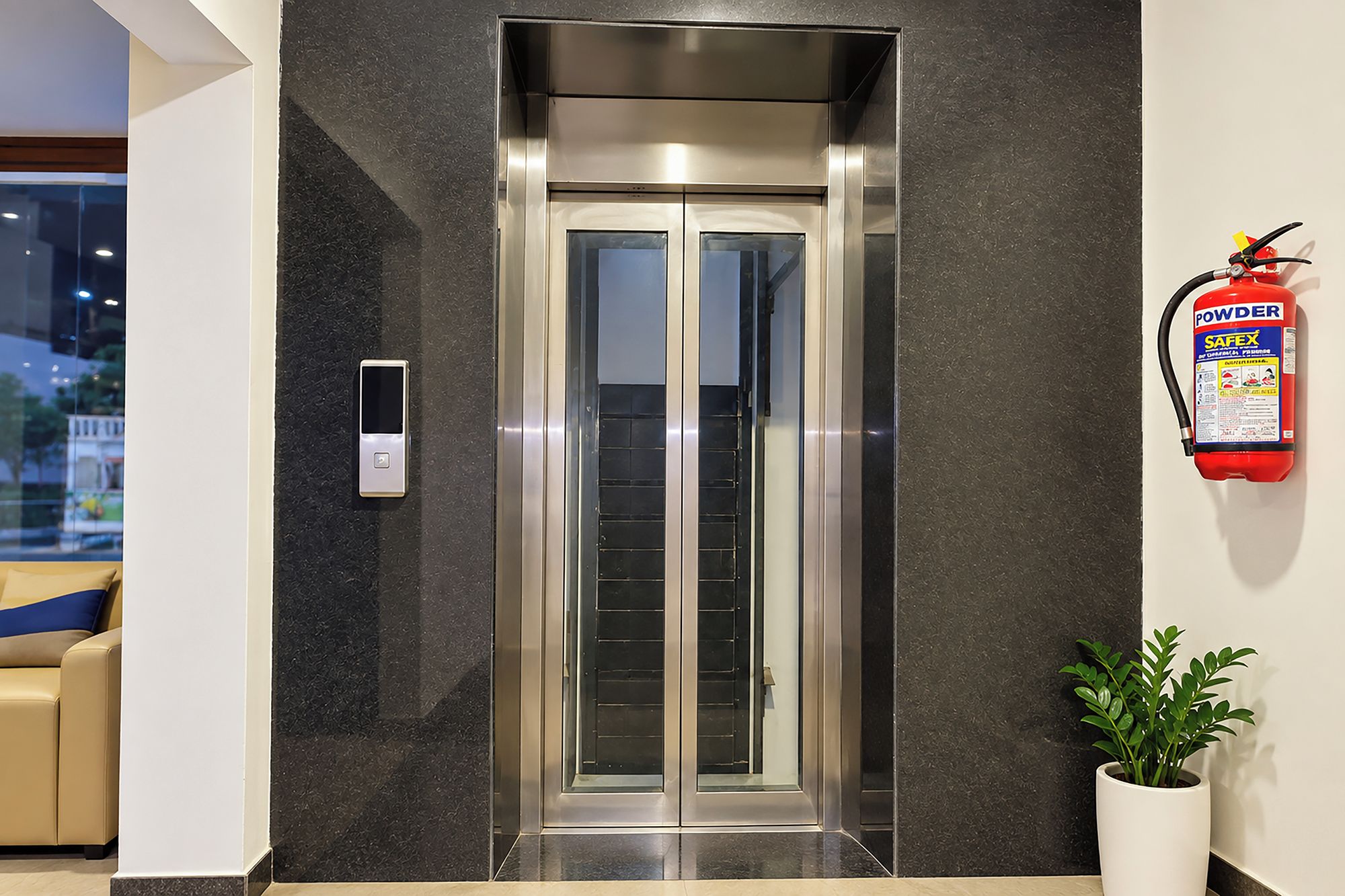 An elevator with a fire extinguisher mounted on the wall beside it.