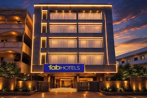 A multi-story hotel with a modern facade, large windows, and a prominent 'fab hotels' sign.