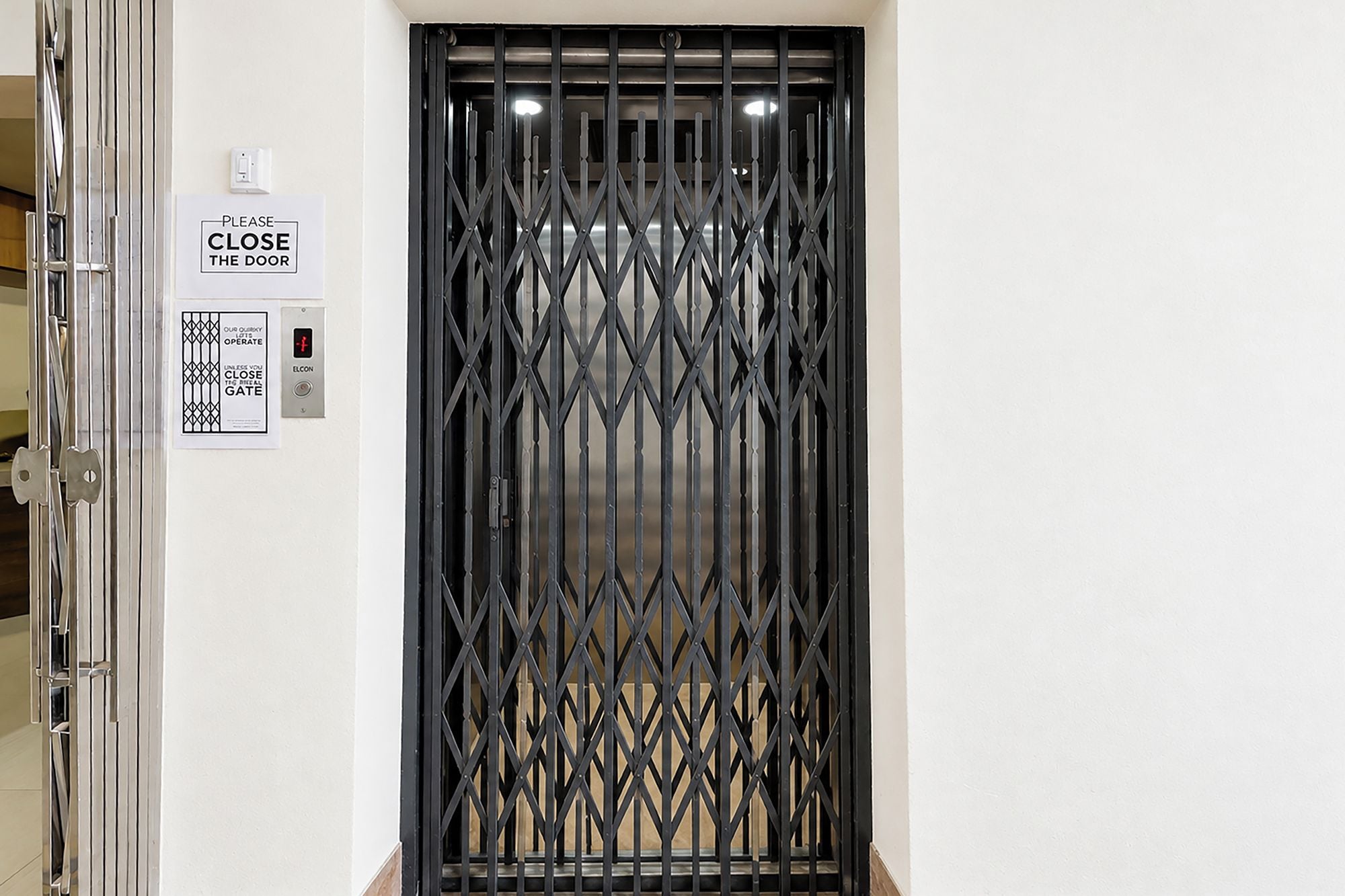 A door with a security gate and a sign instructing to close the door.