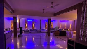 A spacious lobby with a polished floor, seating areas, and ambient lighting. - Fabhotel Aravali Residency (Gurugram)