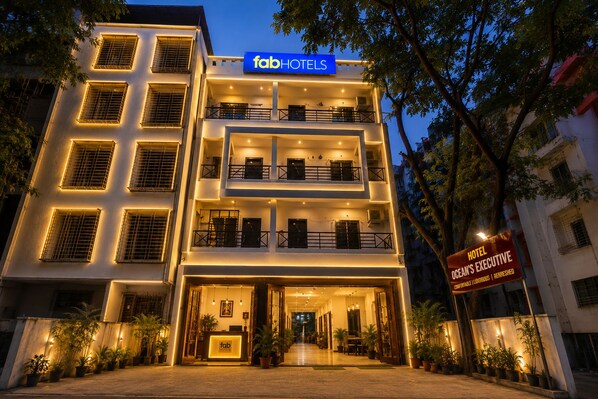 A multi-story hotel with a reception area, balconies, and a sign indicating the hotel executive.