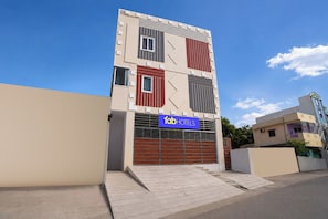Un edificio moderno con un cartel que indica 'fab hotels', identificándolo como un establecimiento hotelero.