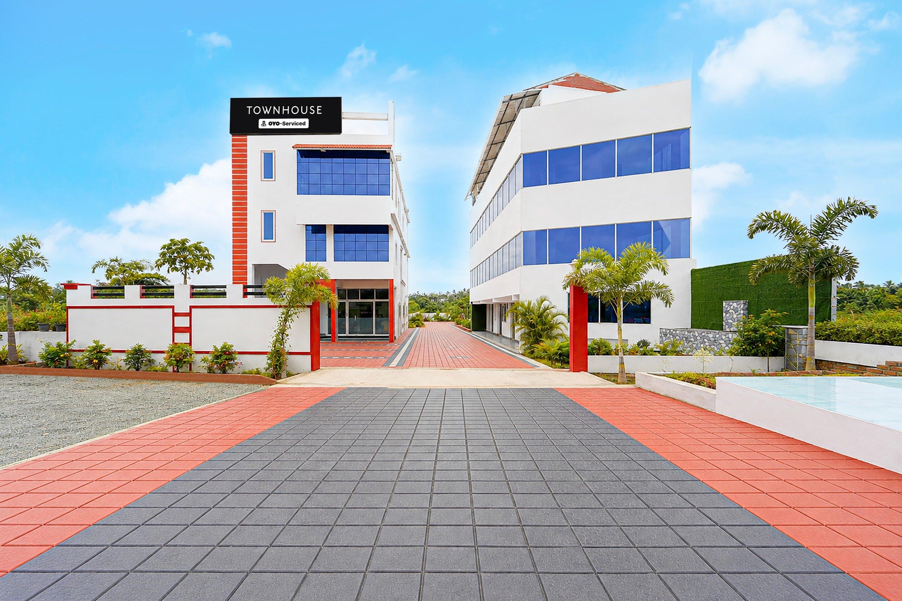 A modern building with a sign indicating it is serviced by OYO.