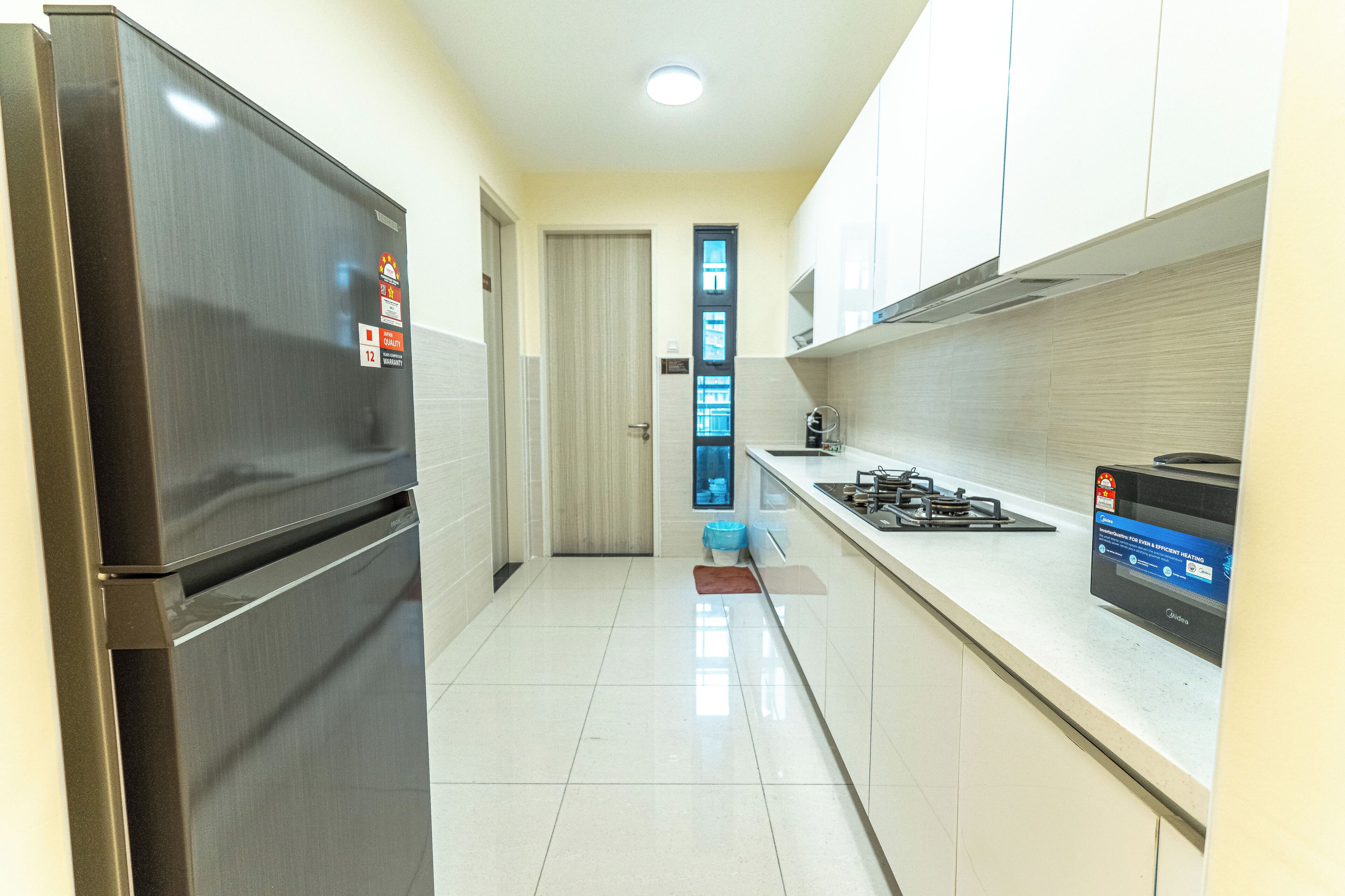 A modern kitchen with stainless steel appliances, a tiled backsplash, and a gas stove.