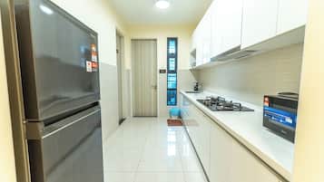 A modern kitchen with stainless steel appliances, a tiled backsplash, and a gas stove.