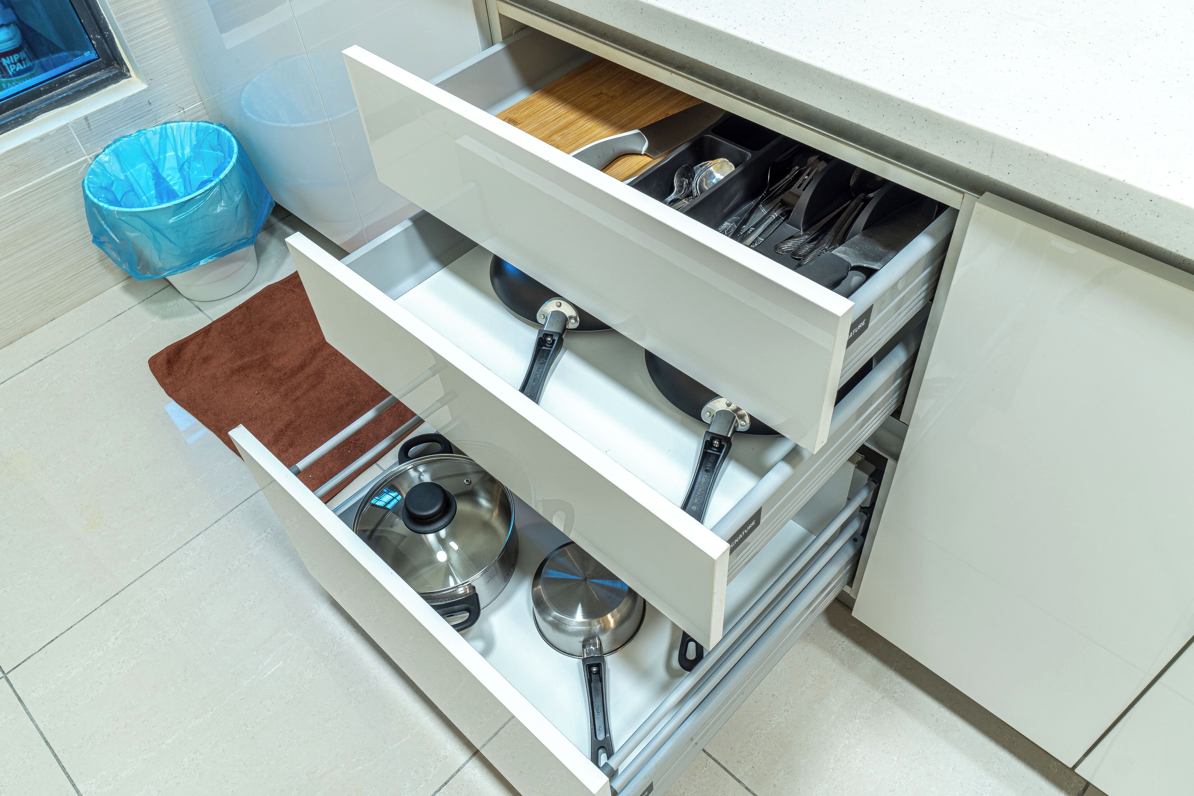 A kitchen drawer with utensils and cookware.