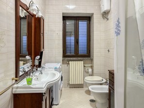 A bathroom with a sink, mirror, toilet, and window. - Casa Mercò - At the foot of Mount Partenio (Mercogliano)