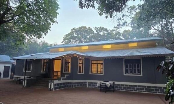 A two-story building with a flat roof and a porch area. - Shalimar in the Forest (Mumbai)