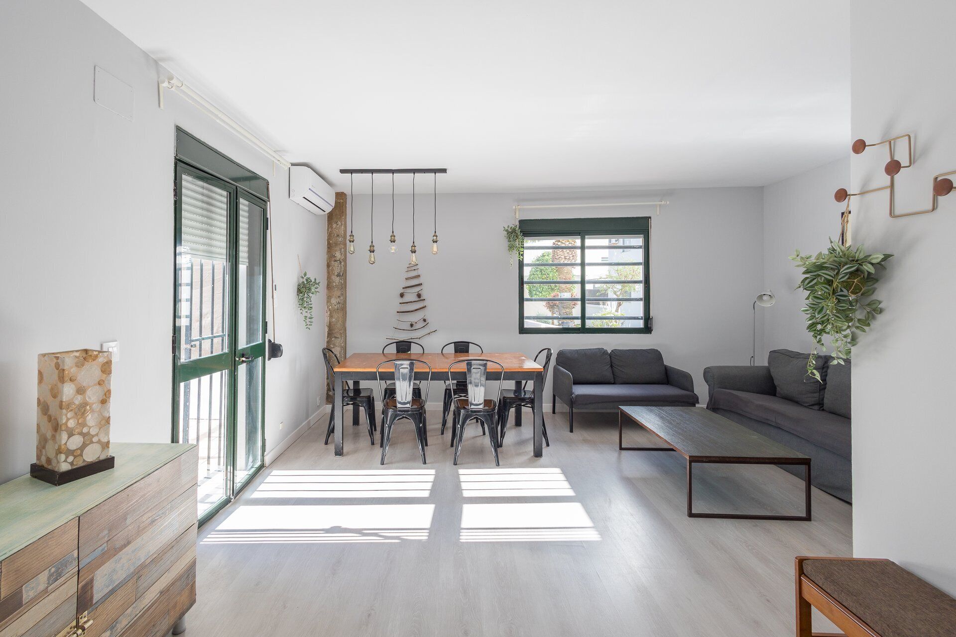 Un espacio moderno para vivir con comedor, sofá y vistas al exterior.