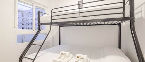 A bunk bed with a window, a towel, and a sign indicating 'guest ready'.