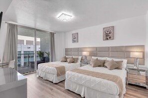 A modern hotel room with two beds, a balcony, and a view of the city. - 2 Penthouses Sleeps 14 · Brickell, Free Parking (Miami)