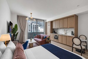 A modern hotel room with a bed, a sofa, a dining area, and a kitchen. - 2 Units on One Floor for 8 · Wynwood Rooftop Pool (Miami)