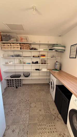 A laundry room with a washing machine, dryer, shelves with storage bins, and a coffee maker. - A peaceful retreat with a pool and a view of the countryside (Preignan)