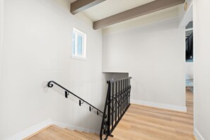 A staircase with a metal handrail and a small window on the wall. - Waterfront Retreat w/ Dock, Hot Tub & Views (Bethel Island)
