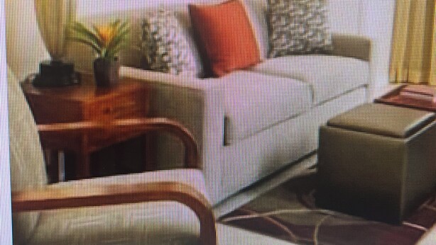 Ein Wohnzimmer mit einer Couch, einem Couchtisch und einem Sessel.