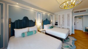A hotel room with two beds, a chandelier, a desk, and a wardrobe. - Orlando | Upscale Disney Stay | Pool + Spa (Lake Buena Vista)