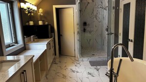A modern bathroom with a glass-enclosed shower, a large bathtub, and marble flooring. - Grizzly - Private Luxury Unit near DT and 17th Av (Calgary)