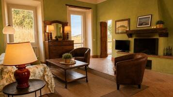 A cozy living room with a fireplace, comfortable seating, and a television.