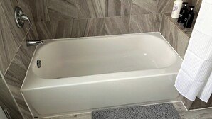 A bathroom with a bathtub, a shower, and a towel rack. - Elk - Private Bedroom near Downtown and 17th Av (Calgary)