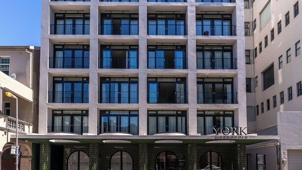 A multi-story hotel with a modern facade, large windows, and a prominent entrance with a sign reading "YORK METROPOLIS". - City Views, Shared Gym, Cape Town -York Cityscape Apt (Cape Town)