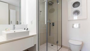 A modern bathroom with a glass-enclosed shower, a white sink, and a toilet. - Views, De Waterkant CPT, Communal Pool -901 Mirage (Cape Town)