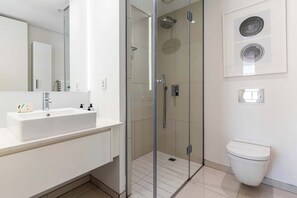 A modern bathroom with a glass-enclosed shower, a white sink, and a toilet. - Views, De Waterkant CPT, Communal Pool -901 Mirage (Cape Town)