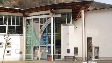 A building with a modern architectural style, featuring large glass windows and a prominent entrance.