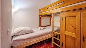 A bunk bed with a wooden ladder and a wardrobe. - Alpine Stay w/ Private Ski Views (Les Belleville)