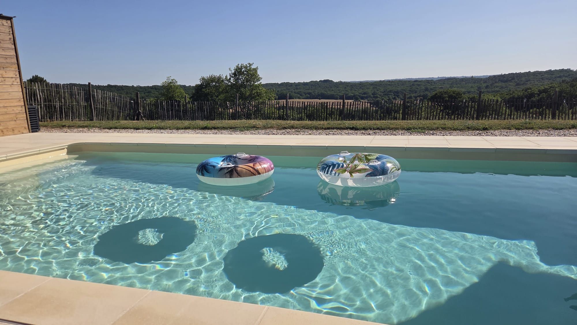 A swimming pool with two inflatable rings.
