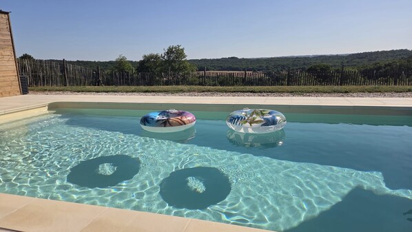 A swimming pool with two inflatable rings.