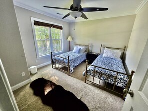 A bedroom with two beds, a ceiling fan, a window with curtains, and a carpeted floor. - 4 Bedroom Spacious Home Near Market (Thomasville)