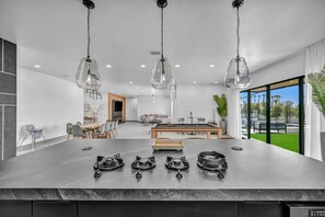 A modern kitchen with a central island, dining area, and a pool table. - The signature Luxury Las Vegas Getaway (Las Vegas)