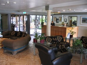 A lobby with a reception desk, seating area with sofas, and potted plants. - Christmas in Park City Ski Condo, slps 6, full kitchen, ski shuttle, Dec. 19-26 (Park City)