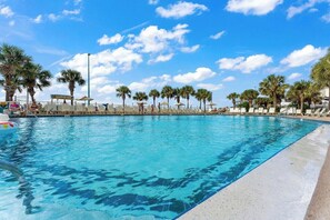 A clear blue pool with lounge chairs and palm trees. - The Summit 225 - Ocean Views & Beach Vibes (Panama City Beach)