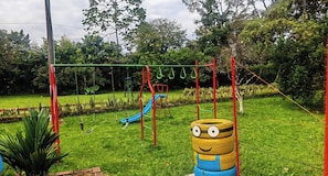 A playground with a slide and swings.