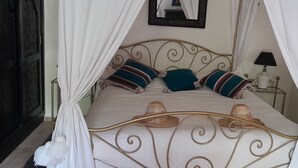 A four-poster bed with a canopy, pillows, and a bedside table with a lamp. - The Perfect Vacation, 20 Minutes from the Airport in the Marrakech Countryside, Sleeps 12 (Marrakech)
