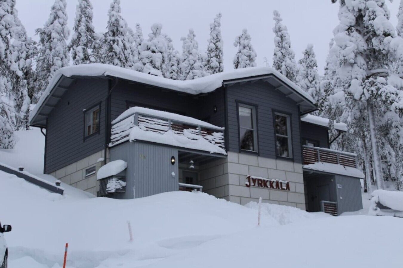A two-story building with a snow-covered roof and a sign that reads 'JYRKKALA'.