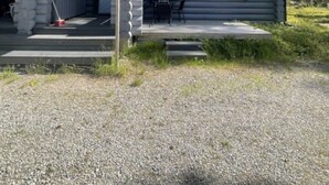 A log cabin with a porch and a small deck area. - Mäntyruka A2 | Cozy 1BR Cabin | Sauna & Fireplace (Ruka)